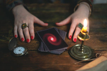 Tarot cards and a woman fortune teller. Future reading concept. Divination.