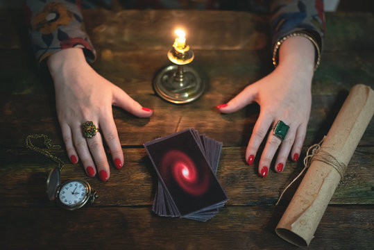 Tarot cards and a woman fortune teller. Future reading concept. Divination.