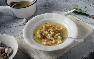Smoked meat soup with pasta inside