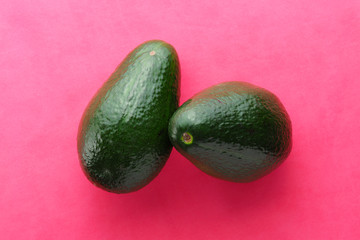 Ripe Green Avocado on Red Background