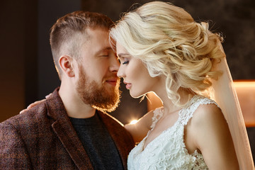 Love, tenderness, faithfulness and care in every touch. Happy couple. Couple hugged and kissed after the marriage. The bride and groom hug each other and look into their eyes