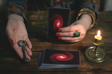 Tarot cards and a woman fortune teller with a unravelling key of fate. Future reading concept....