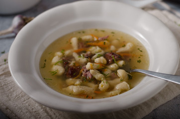 Smoked meat soup with pasta inside