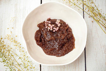 Coffee body scrub in a porcelain bowl on a background. flat lay