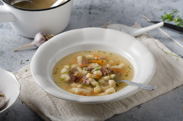 Smoked meat soup with pasta inside