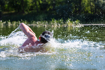 The young man swimming in the river