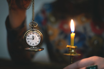 Brass pocket watch with arrows on a almost twelve o clock  in a hand of a woman. Time to tell a secrets or go bed to sleep.