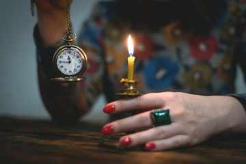 Brass pocket watch with arrows on a almost twelve o clock  in a hand of a woman. Time to tell a...