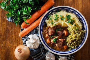 Traditional irish stew served with potatoes and cabbage