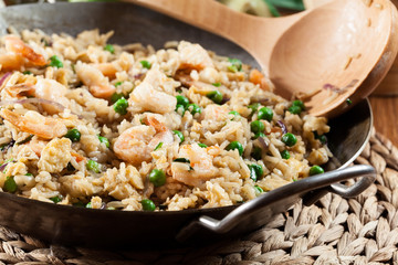 Fried rice with shrimp and vegetables on a frying pan