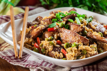 Fried rice with chicken and vegetables served on a plate
