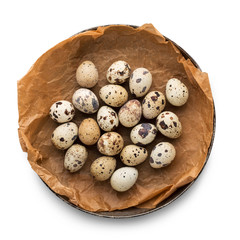 Quail easter eggs in bowl on brown parchment