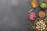 Easter holiday greeting background, with colorful candies and quail eggs
