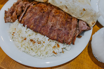 Turkish Doner Kebab, Shawarma or Gyros with rice. Traditional Turkish Doner Kebab meat, iskender, shawarma or gyros in restaurant