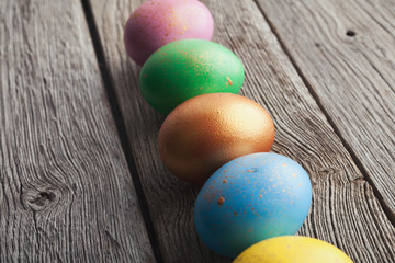 Obraz na płótnie Canvas Row of easter eggs on wooden background.