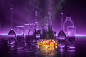 Pharmacy and chemistry theme. Test glass flask with solution in research laboratory. Science and medical background. Laboratory test tubes on dark toned background