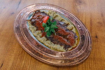 Turkish Doner Kebab, Shawarma or Gyros. Traditional Turkish Doner Kebab meat, iskender, shawarma or gyros on copper plate or pan in restaurant