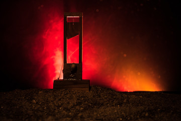 Horror view of Guillotine. Close-up of a guillotine on a dark foggy background.