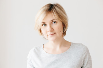 Middle aged woman on light background