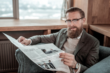 Attractive young businessman looking straight at camera