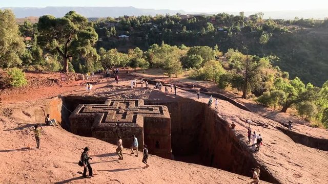 The rock-hewn monolithic Church of St. George at Lalibela, Ethiopia; visited by large group of tourists both local and international, December 2018, tc01