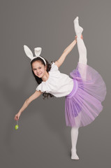 Flexible little girl doing vertical split