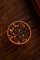 Peppercorns in a wooden bowl on table with food rustic style. Homemade food