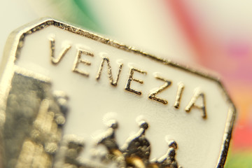 Souvenir badge with the designation of the city of Venice. Close up. Toned.