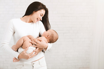 Young mother hugging her cute newborn child