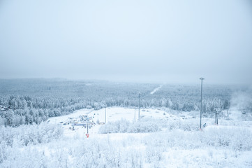 Winter landscape, mountain view of the forest in the snow, spruce and pine, sky and mountains . Ski resort