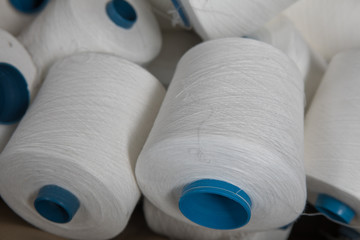 Yarn threads spools of thread bobbin tubes. Textile background concept image