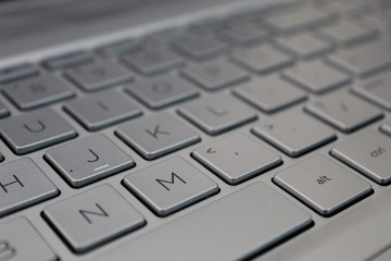 A  closeup picture of keyboard of a laptop.