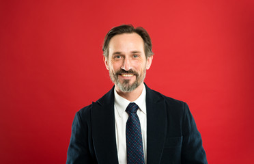 Man handsome mature fashion model wear fashionable suit on red background. Suit imbue sense of confidence of gentlemen. Bespoke suit flatters every wearer. Perfect suit for every type of guy