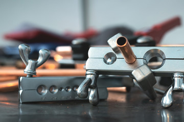 Pipe rammer tool on a fitter workbench. Pipework concept background.