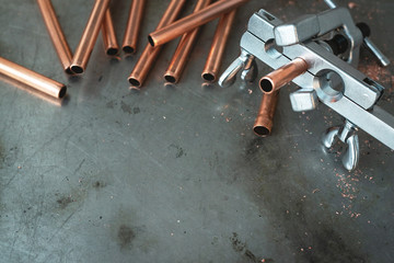 Pipe rammer tool on a fitter workbench. Pipework concept background with copy space.