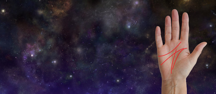 Palm Reading Cosmic Background - female hand facing out showing the main head heart life and fate lines against a wide deep space night sky background with copy space 