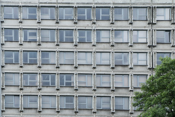 A picture of an old communist building. It is an illustration of the brutalist architecture of the past. 