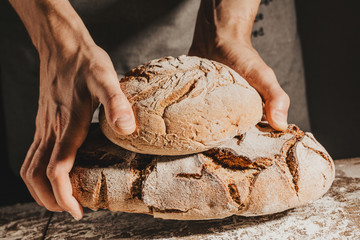Baker or chef holding fresh made bread