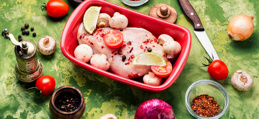 Raw chicken in baking dish