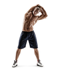 Athletic man doing exercises for stretching the lateral muscles of the trunk. Photo of muscular man...