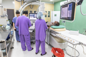 The doctor is conducting a patient examination in Digital Subtraction Angiography Room, DSA lab,...