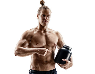 Sportsman holds large bank with protein nutrition in hand. Photo of muscular man with naked torso...