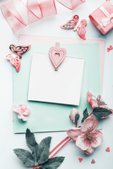 Lovely greeting card mock up with pastel pink heart , flowers and decoration, top view, flat lay. Can using to Mothers day, wedding, birthday , Valentines day