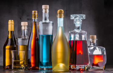 Carafe and bottles of assorted alcoholic beverages.