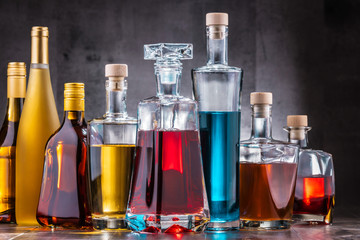 Carafe and bottles of assorted alcoholic beverages.