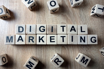 Digital marketing text from wooden blocks on desk
