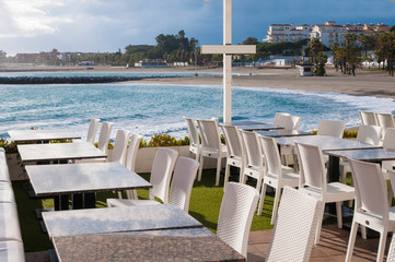 white tables and chairs in a restaurant on the beautiful coast