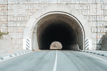 road to the mountains with a tunnel.