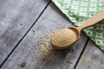 Amaranth seeds in a wooden spoon on table, selective focus. Raw Organic Amaranth Grain