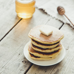 Sweet Homemade Stack of Pancakes with Butter and Honey for Breakfast